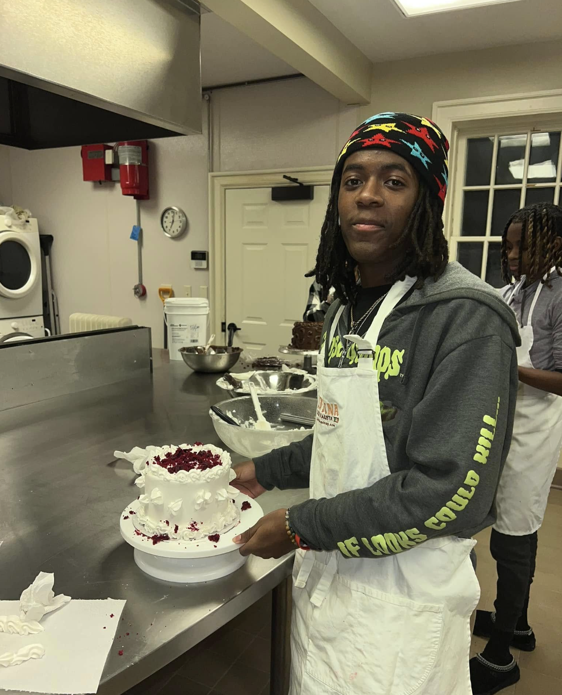Kids laughing while working on cookie cutters and sprinkles