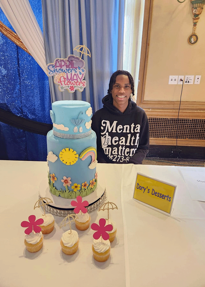 Decorated cake with colorful icing flowers on display at the Expo