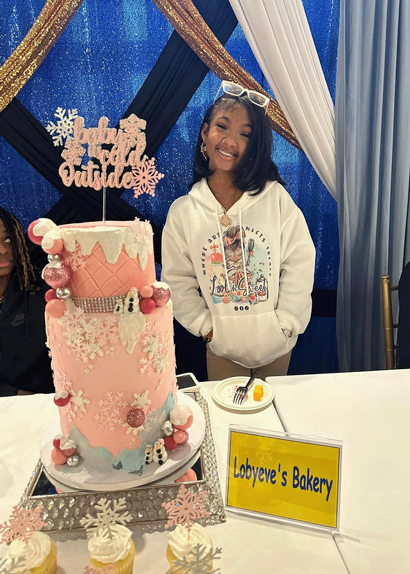 Expo attendees sampling desserts from a local Syracuse bakery booth
