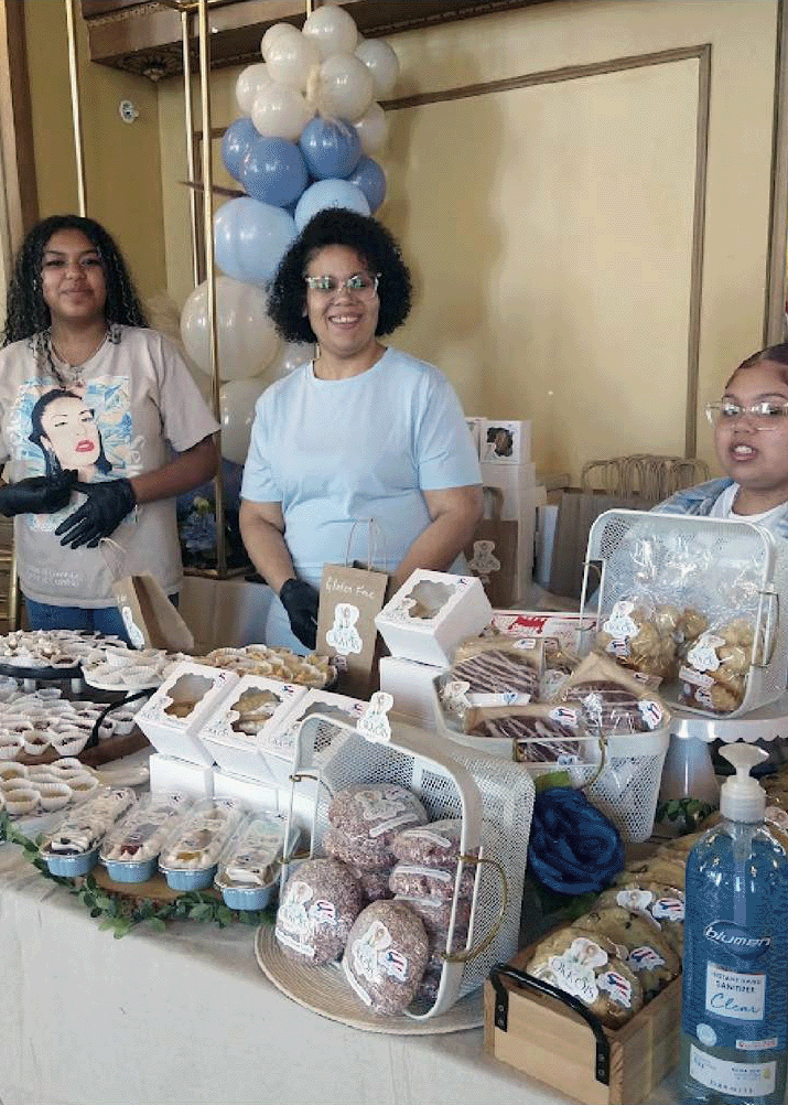 Smiling vendor serving attendees at the Syracuse Bakers Expo