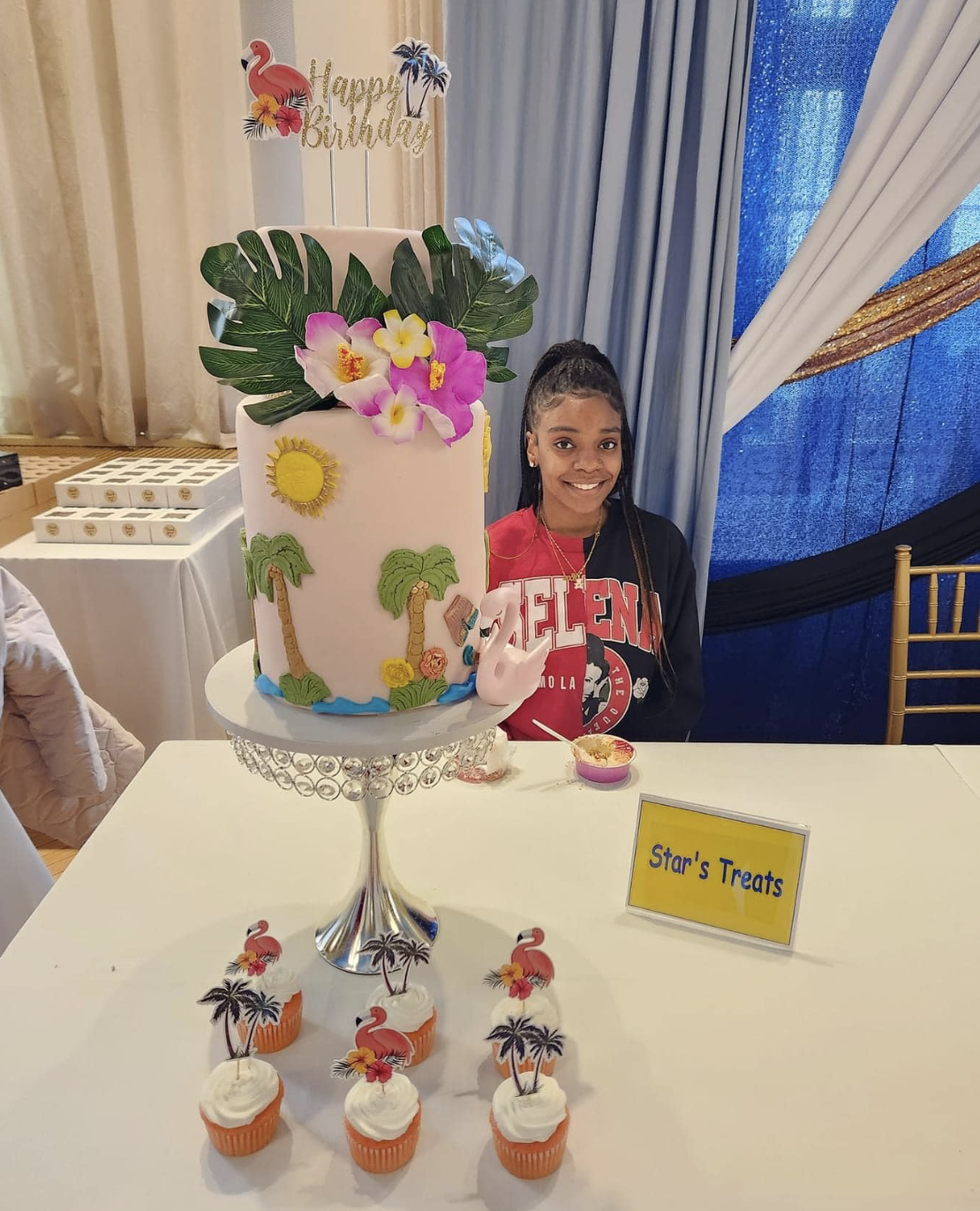 Youth baker showing off color-splashed cupcakes